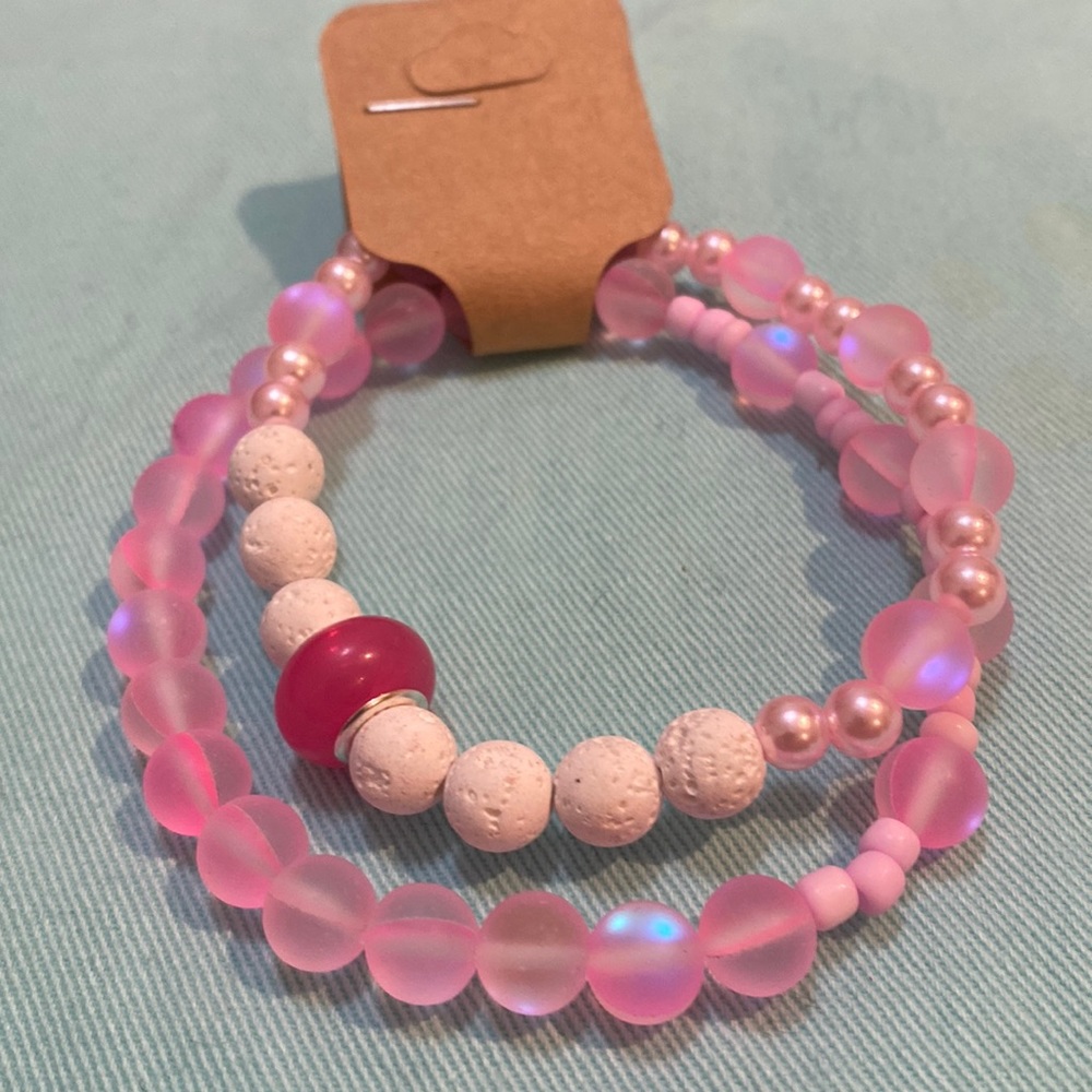 2 illuminating Glass beaded bracelets they change color as the light hits it